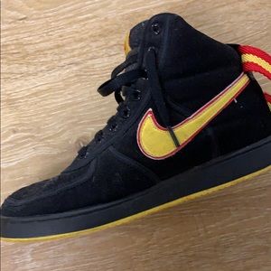 Black and yellow nike mid top air forces